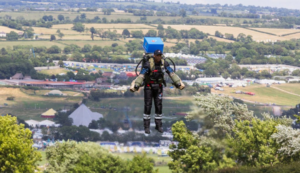 A jetpack pilot carrying a Domino’s pizza delivery during the Rocket Man campaign